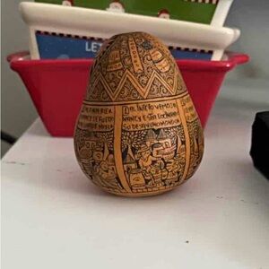 A vintage, hand-etched Peruvian storyteller gourd with Spanish text.